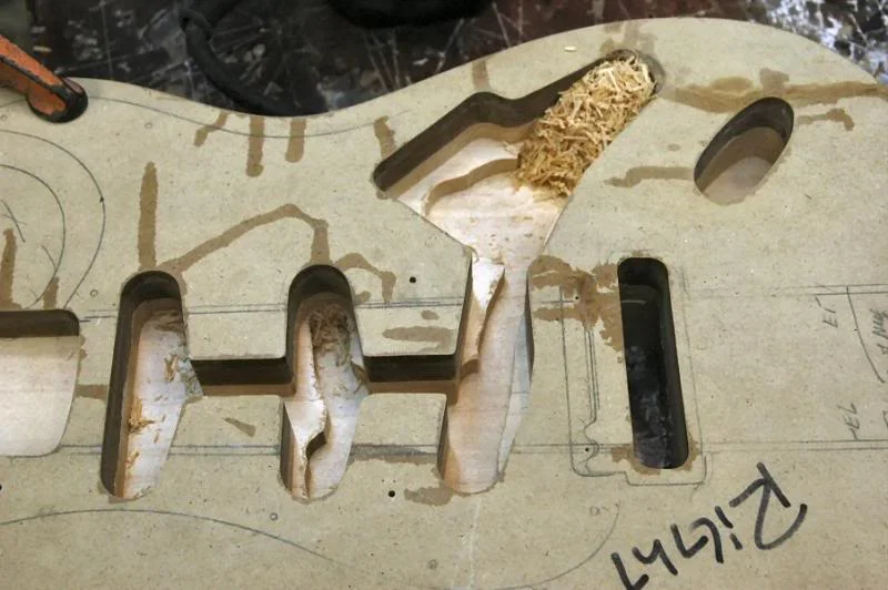 Once that’s done, you can proceed to the electronics/pickup routs. The finished depth should be between 5/8th (vintage) and 3/4 ‘s (more contemporary and allows for more pickup choice). I’m doing ¾ inch. I set the router to cut 3/8ths or ½ the ¾’s. First I plow away the center sections.