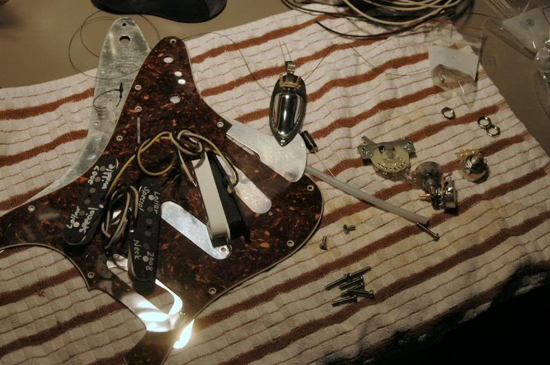  So whadya do with a nice new pickguard, why ya load it up and wire the rascal. So I get all the “stuff” together, and organize it on a specially designed mat specifically intended for assembling state of the art electronics, and wiping up spilled sp