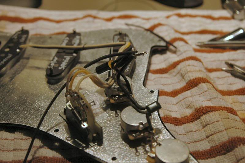  Now I solder the 3 primary pickup leads to the switch, and bundle the 3 ground wires. On most S-types, I will use an isolated ground point, isolated by an audio grade capacitor. There is no sonic change, but the resulting S is as quiet as one with h