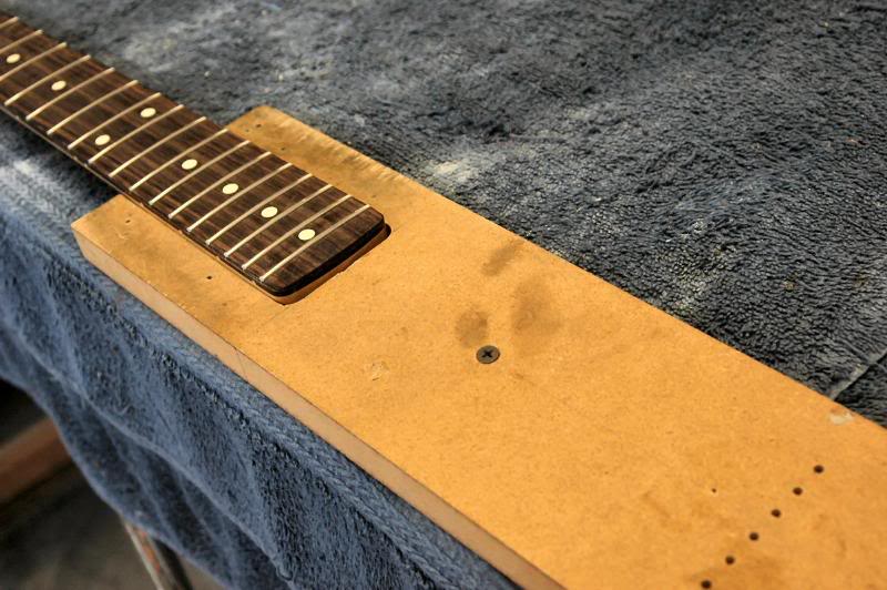  Then use whatever method you’re comfortable with to secure the neck so you have full access to all the frets, all the time and it doesn’t scoot all over the work bench. I just use a piece of MDF screwed to the workbench. 