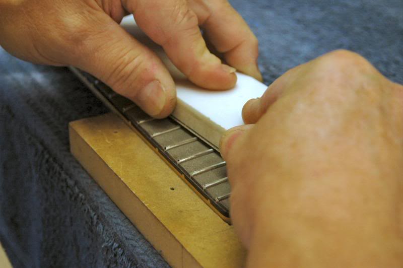  What this does is cut those frets a few ten thousandths lower that the others, allowing for slightly more clearance for the strings. Some neck manufacturers are now offering this as a service, but since the neck needs to be leveled, what’s the point