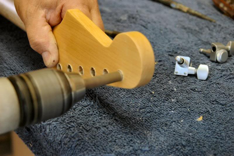  Be very careful reaming. I recommend getting a real reamer. A drill bit will grab the soft wood, chip lacquer, split headstock. You want something that removes wood slowly. A Dremel works well too. This does not have to be a precision fit, just snug