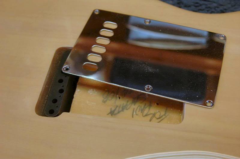  I now place the tremolo over the tremolo unit aligning the string holes in the block with the access holes in the plate. 