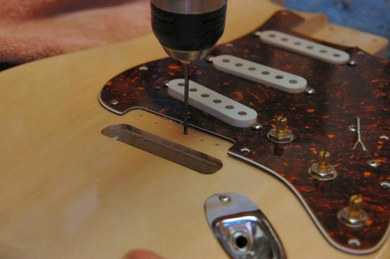  I’ll run in a screw or 2 to secure the location of the pickguard, then place the tremolo to be certain the “dimples” I cut earlier still bring everything into alignment. If good, drill the pilot holes, and countersink them slightly to keep the lacqu