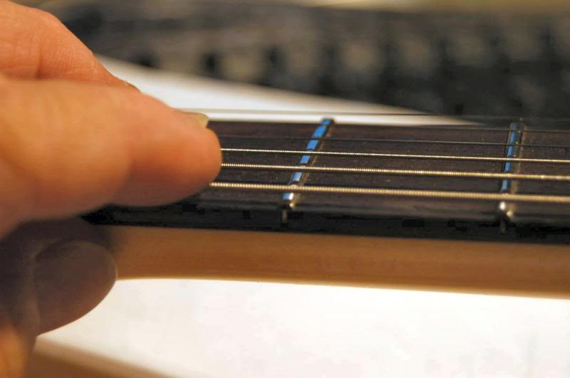  First thing I do is check the relief at the low frets. 