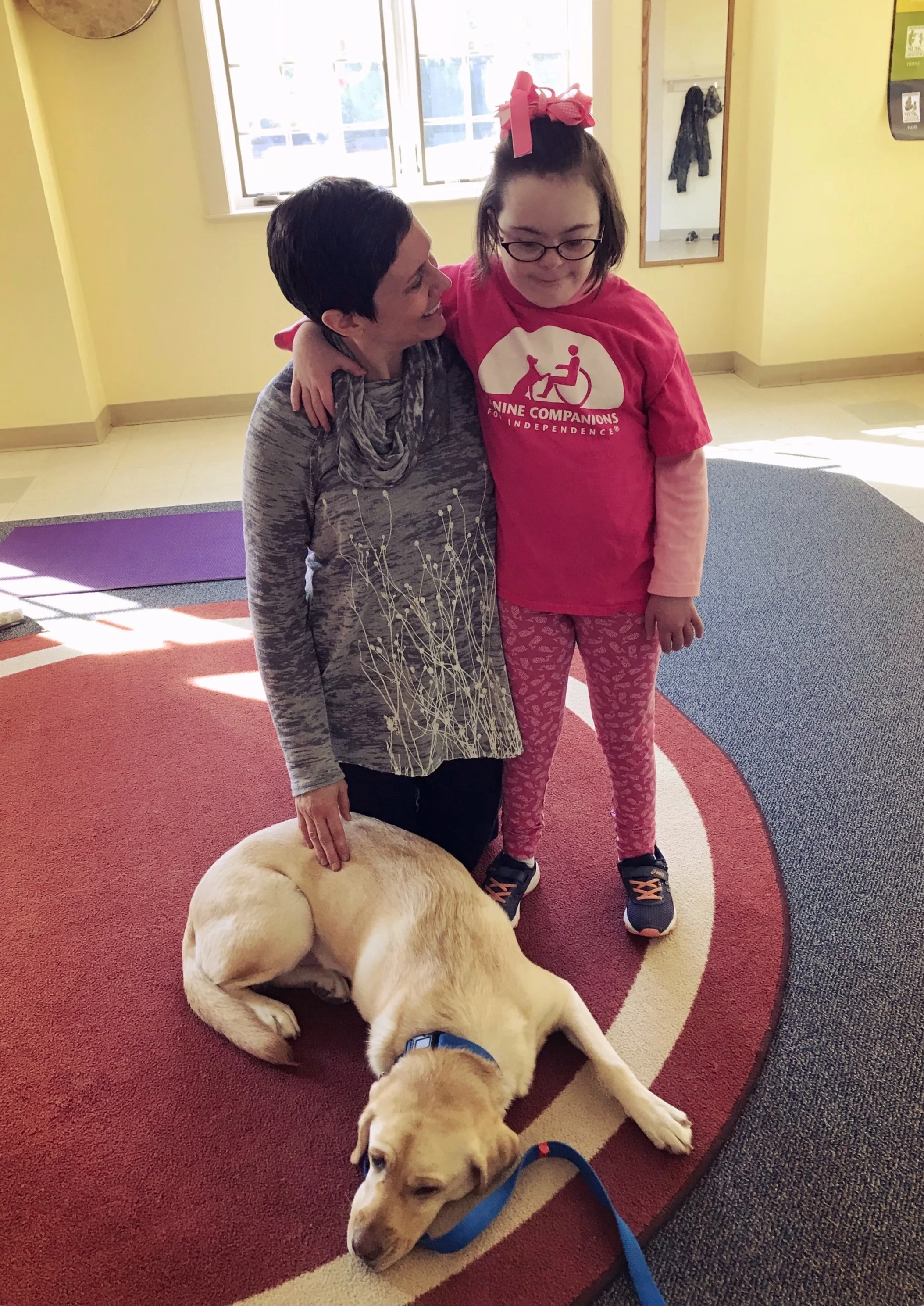 GIta, Molly and service dog Leah relax after a yoga class.