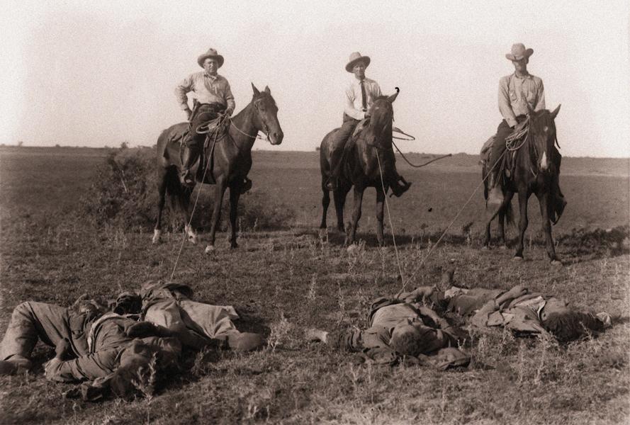 Texas Rangers with killed Mexican raiders. 