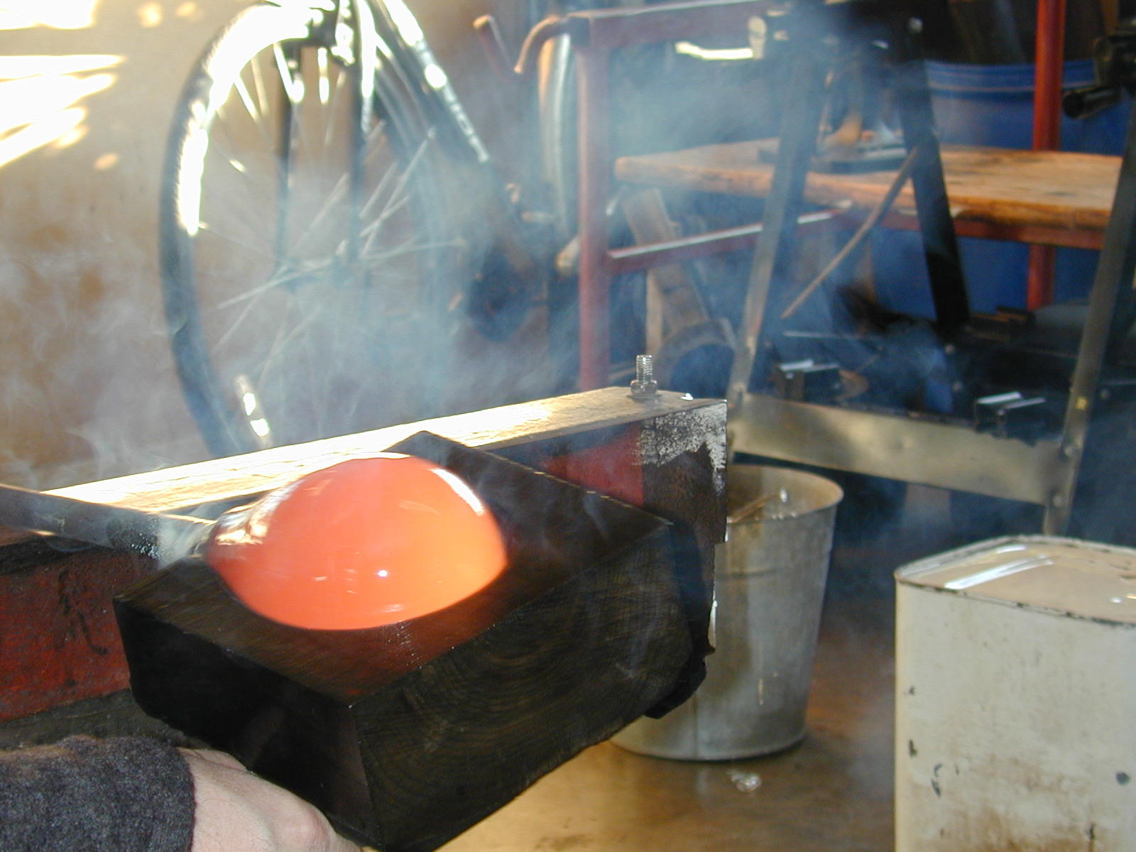 Shaping hot glass with a wooden block