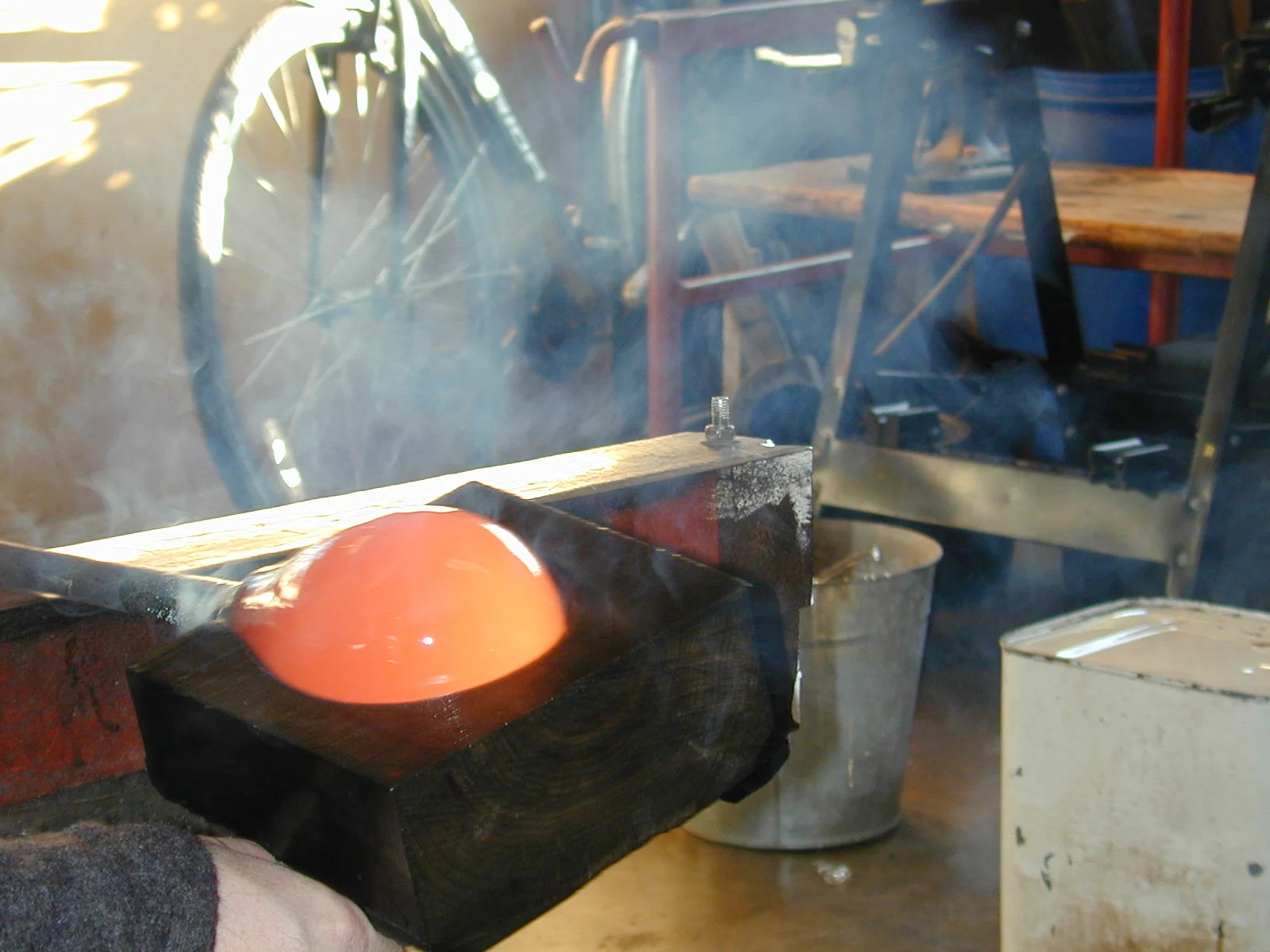Shaping hot glass with a wooden block