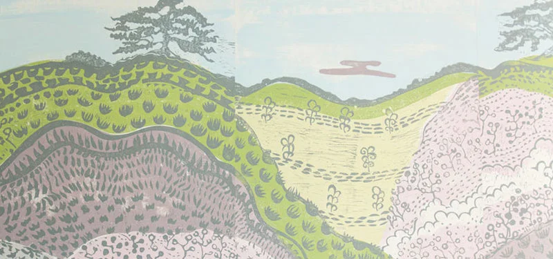 Picture of a wallpaper mural collaboration with Amy Mills of Paper Mills in a hallway designed by CLOTH & KIND in Athens, with a southern landscape of hills in green, light blue and purple. Text on the image reads "Serenbe Textile Lofts Showhouse".