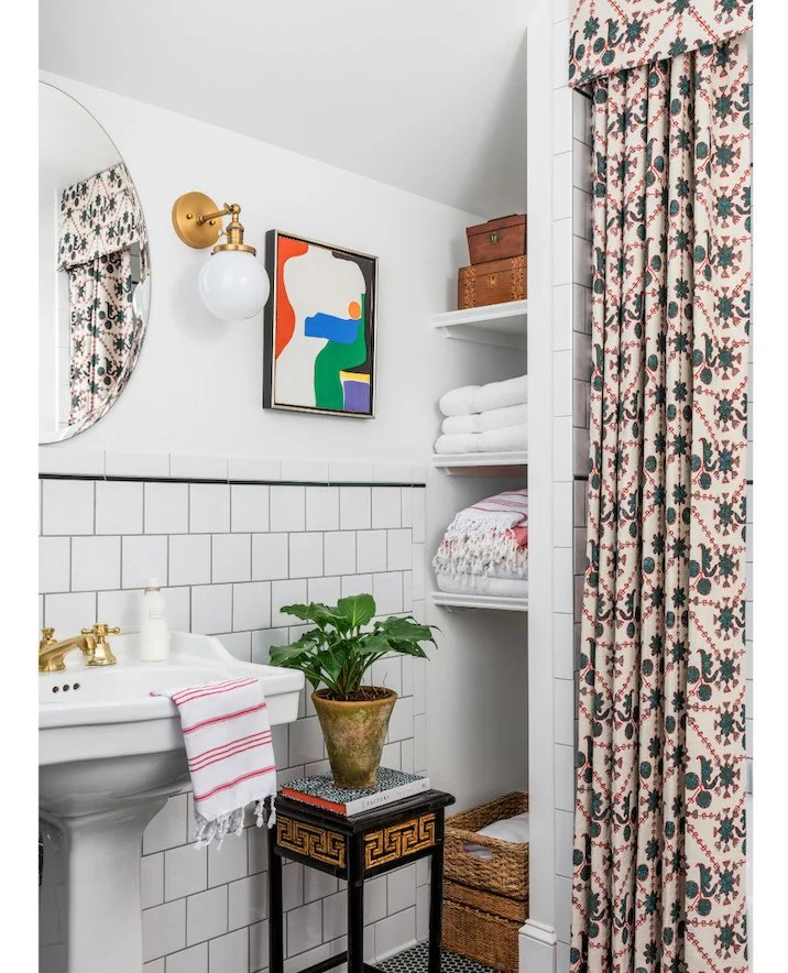 This small, stark white bathroom has been transformed with a vibrant dose of color and pattern. Our favorite part, hands down, is the custom shower curtain. Link in bio to view more from this colorful project. #ckprojectoaklandway⁠
⁠
Interior Design: