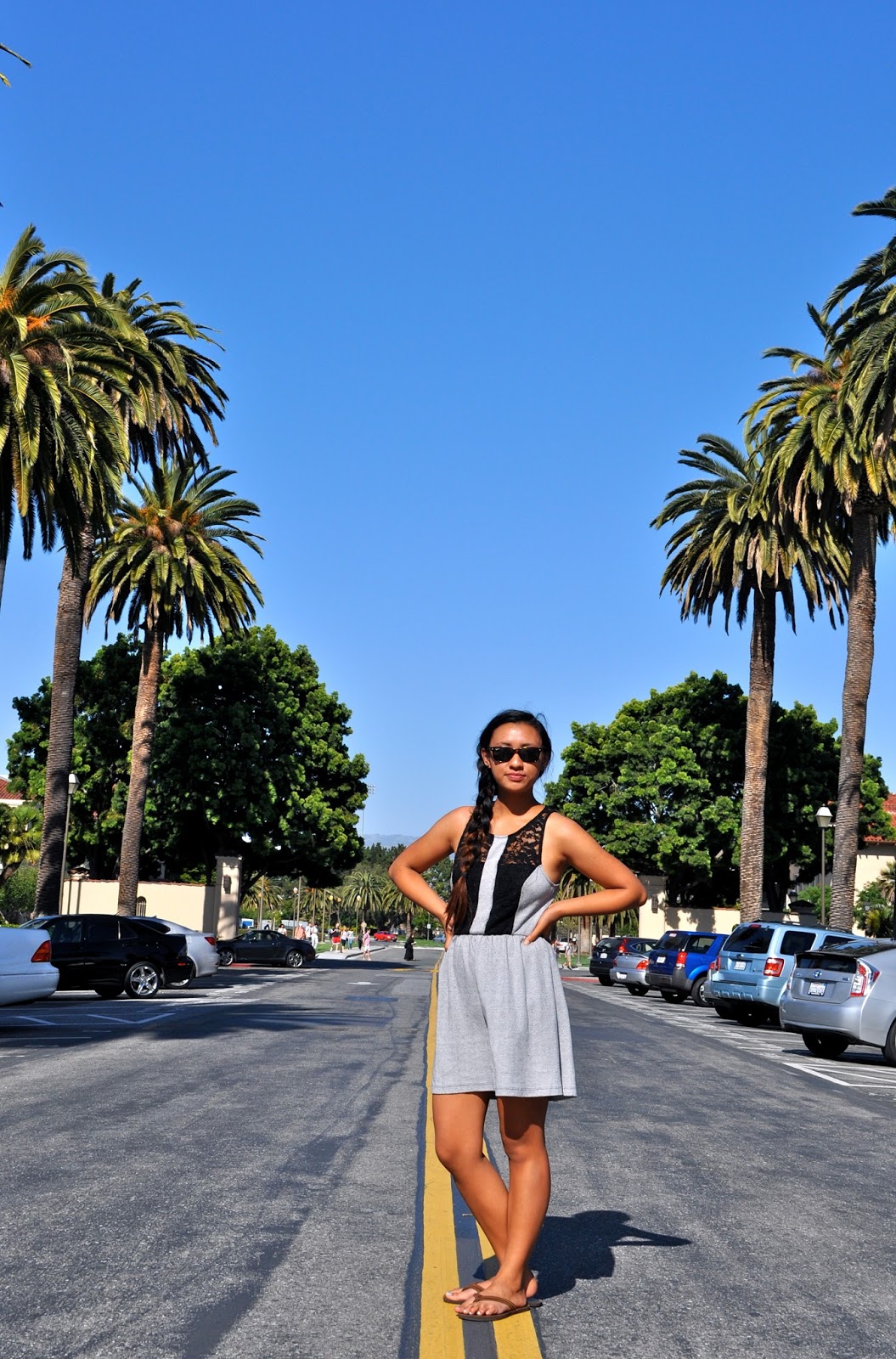 Anjelica, a Santa Clara University student, sporting a grey herringbone dress with a black lace racerback and wearing her hair in a side ponytail