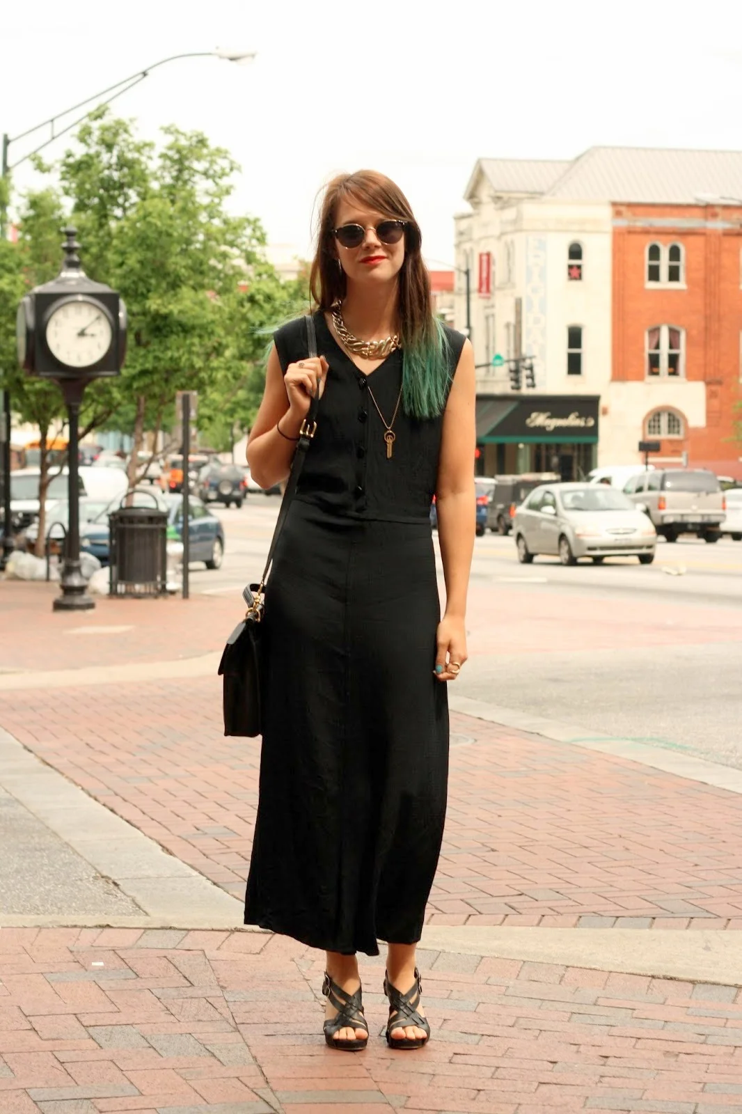 University of Georgia in Athens, GA student wears a long sleeveless black summer dress with leather heel sandals. Keychain necklace