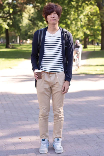 University of Toronto student wears a blue stripe white nautical tee t-shirt under a blue cardigan and over khaki pants and nike sneakers