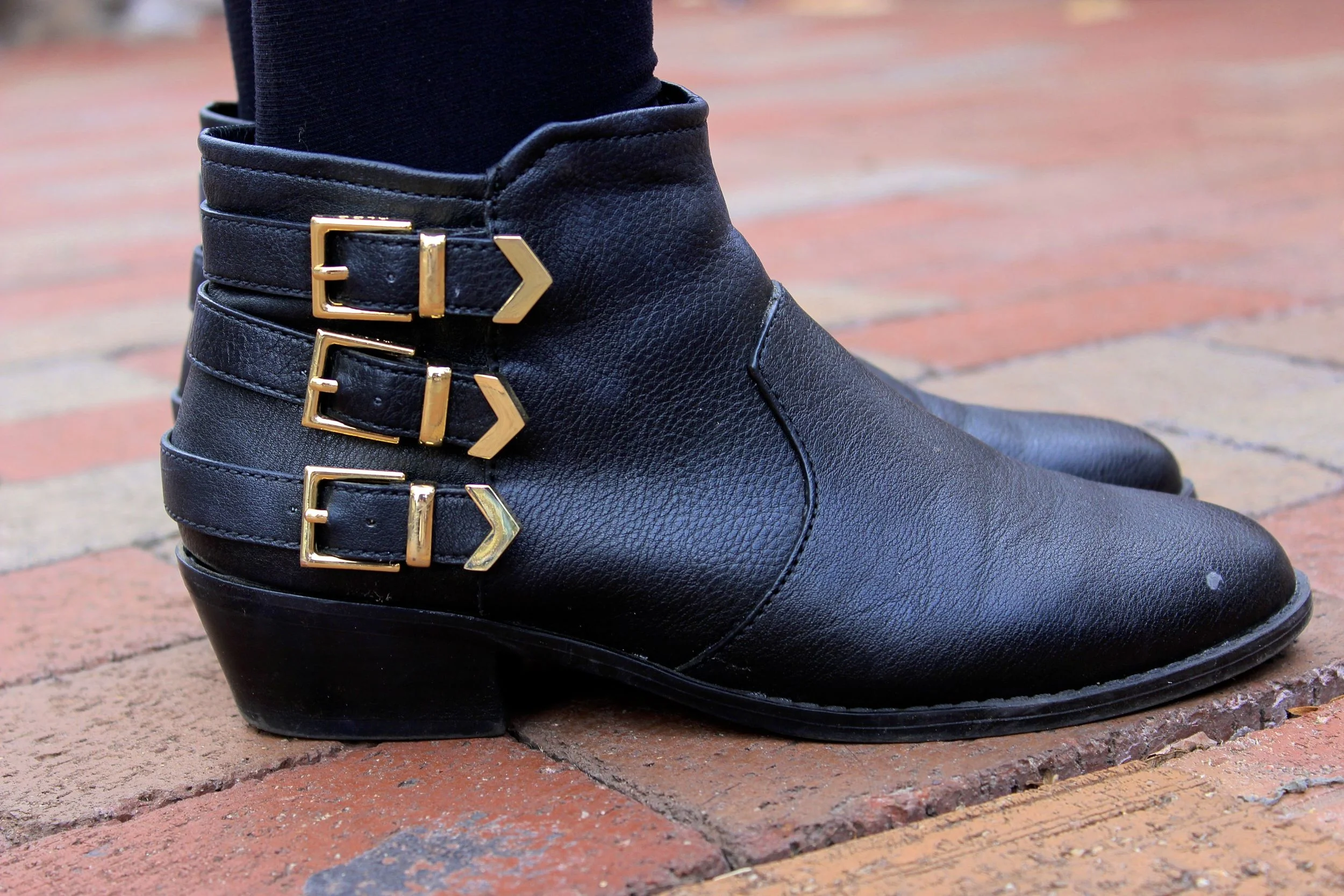 Black Leather booties with golden buckles. College University style