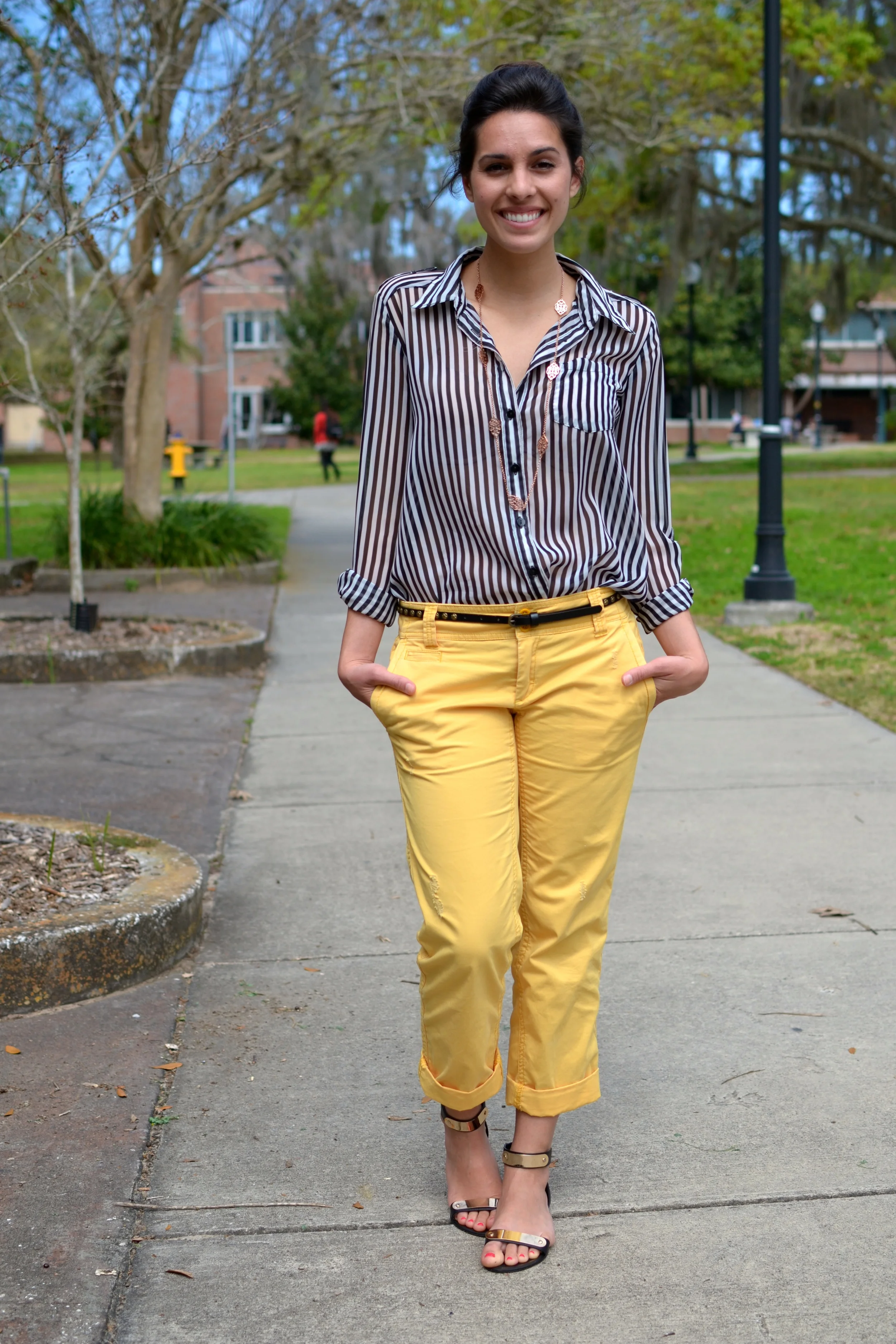 Kelsey is wearing a Sheer Striped Blouse from Macy's and a pair of yellow Piped Khakis from Gap .