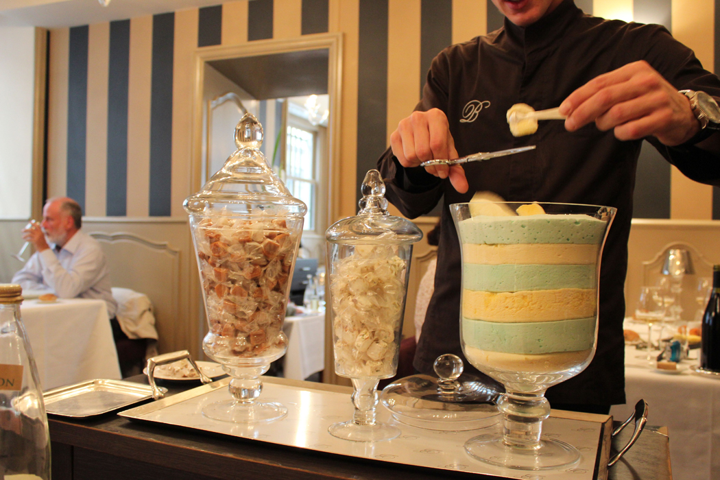 Cutting marshmallow from the dessert cart at La mère Brazier in Lyon.