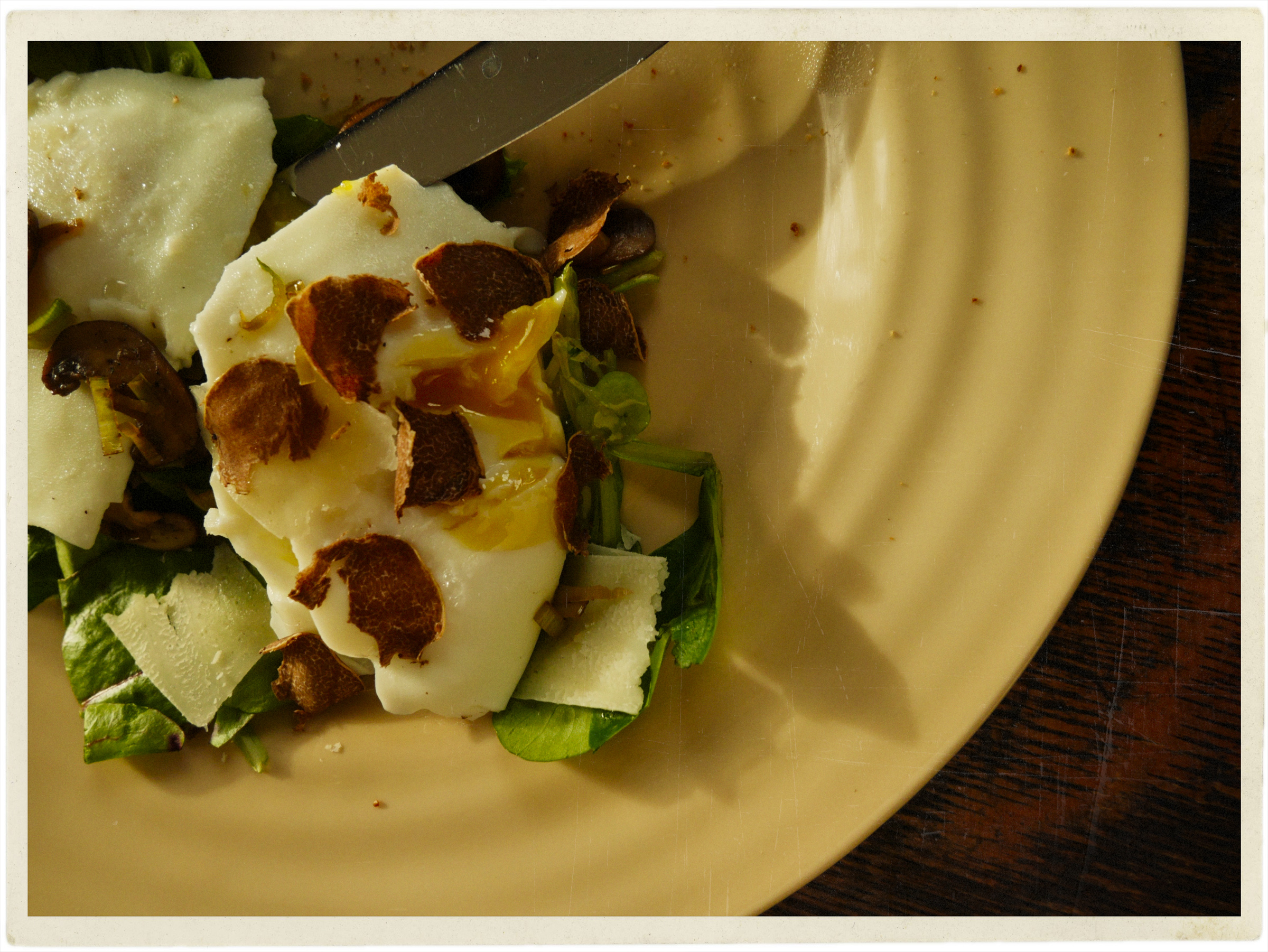 Poached eggs on sautéed mushrooms with greens and topped with shaved truffle.