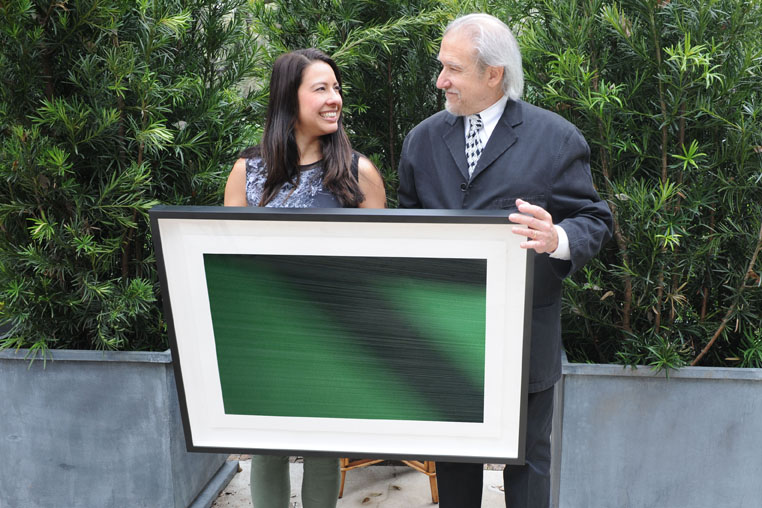 Los Angeles artist Steven Silverstein with a collector and her acquisition, Runway , 20 x 30 inches (50.8 x 76.2 cm), during the art salon at the Hotel Saint Cecilia.