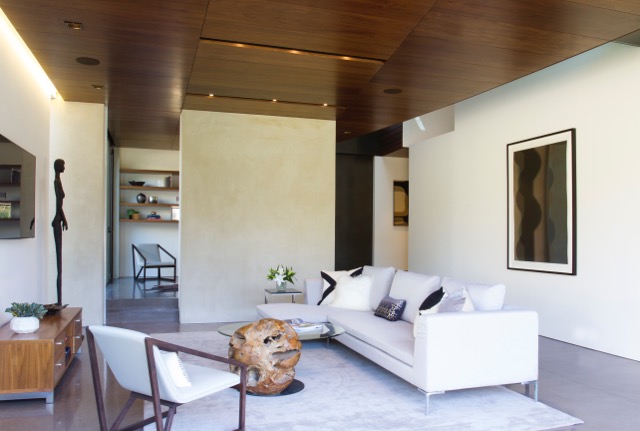 The vertically-oriented curved and columnar shapes in Black Queen (64" x 44", framed) balance the airy volumes and geometry of the living room.