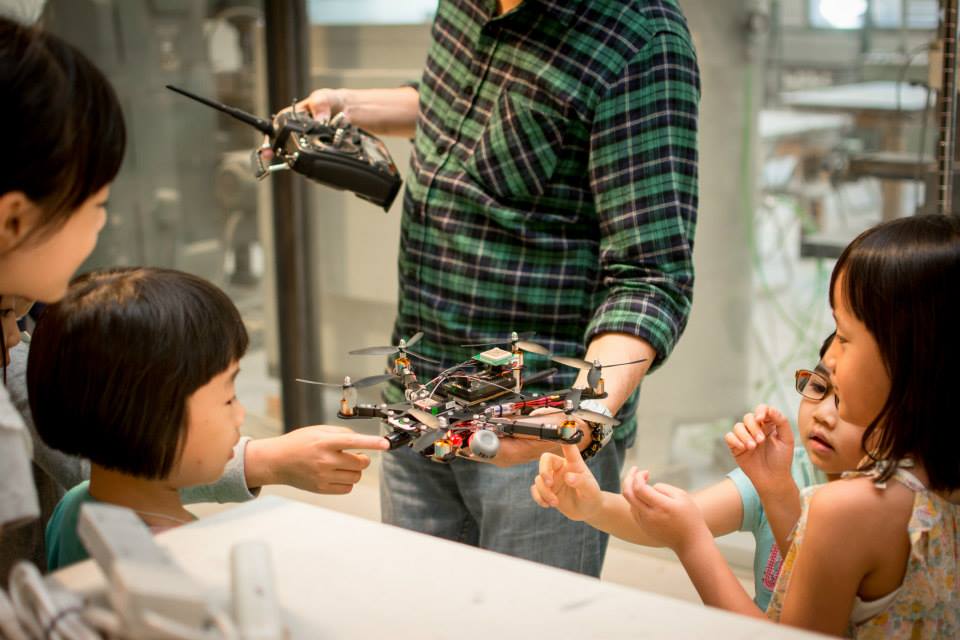 Children are introduced to drones by a workshop teacher.