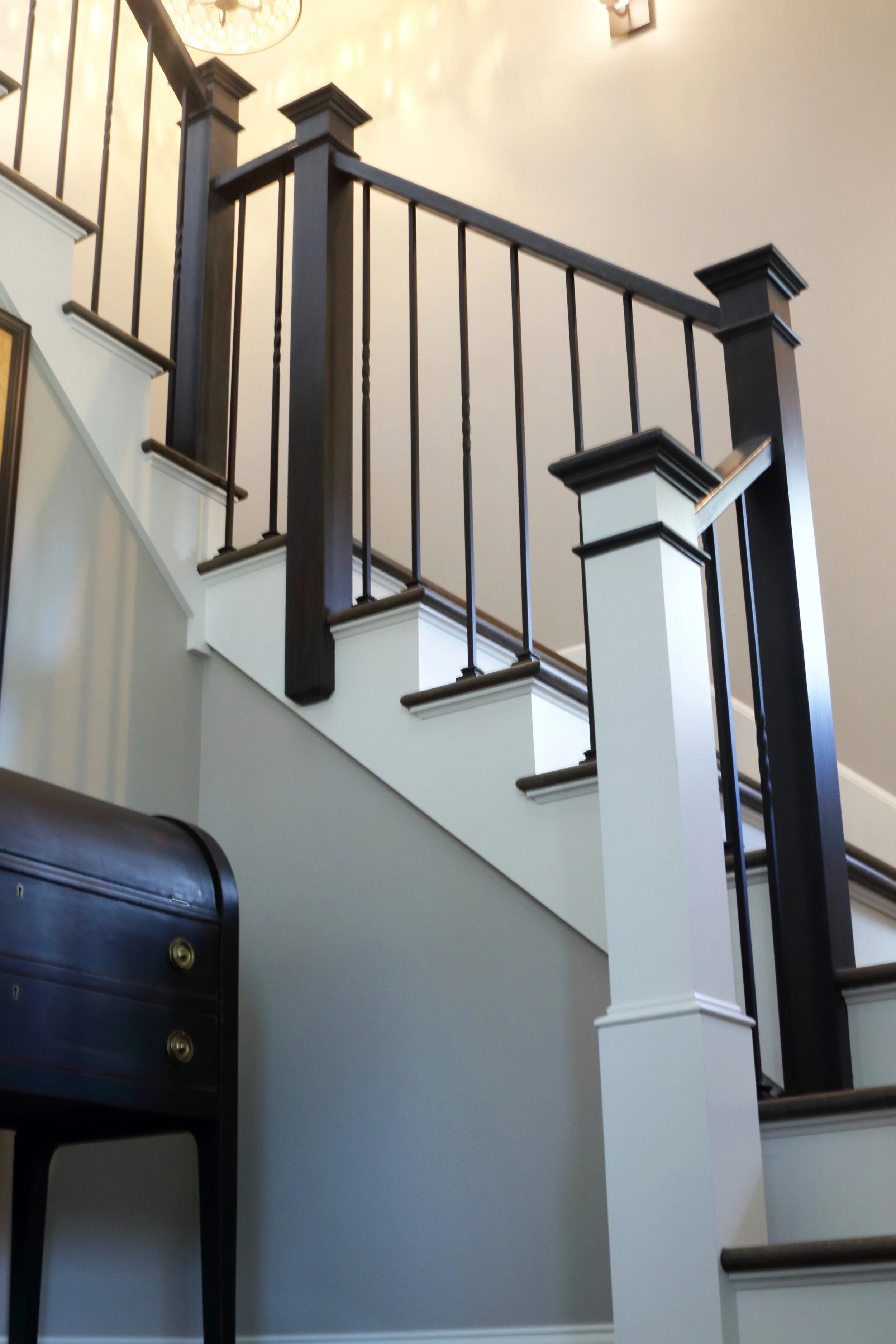 Wrought iron balusters and wood newel posts and top rail