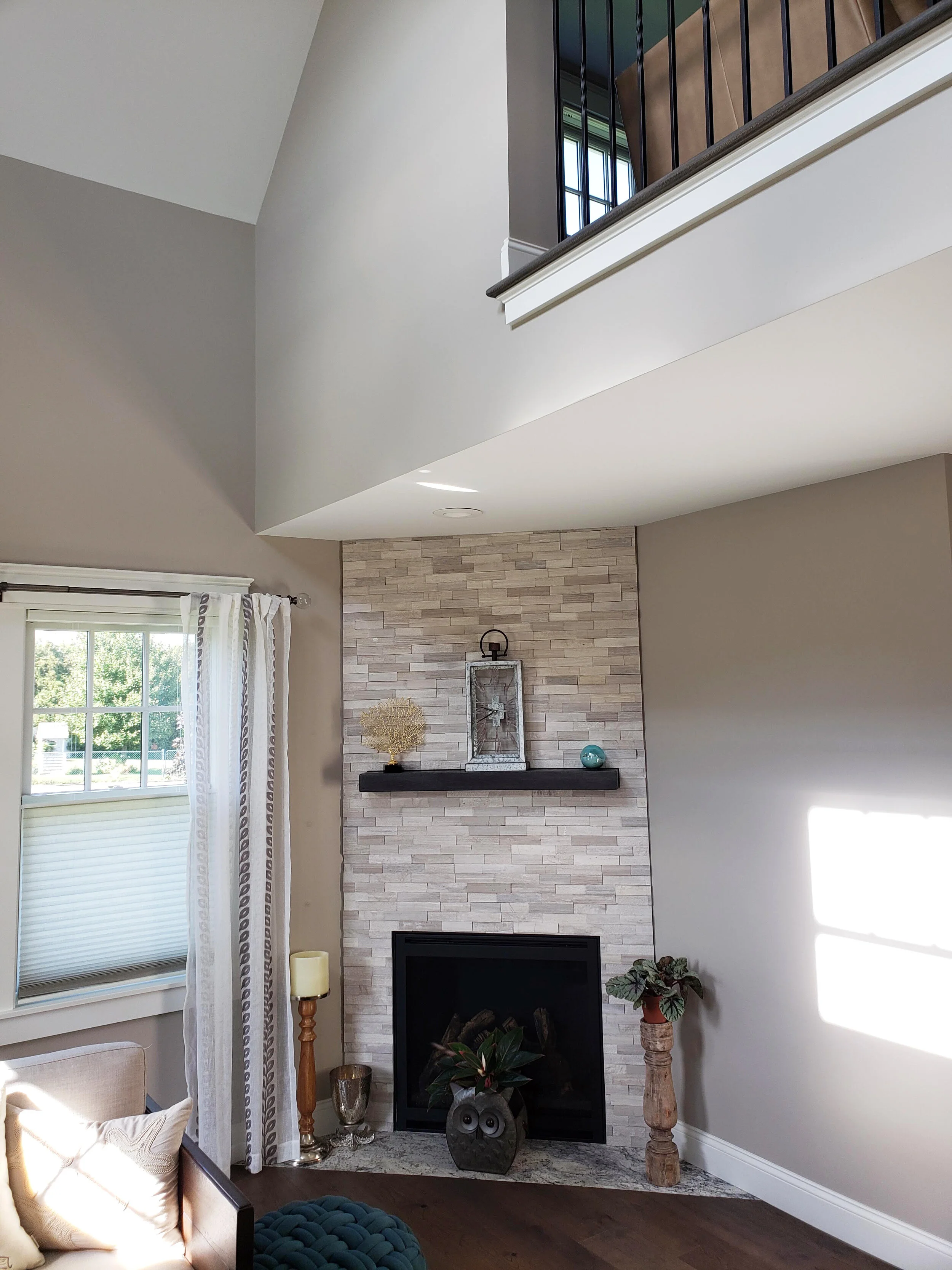 Great Room corner gas fireplace with balcony above