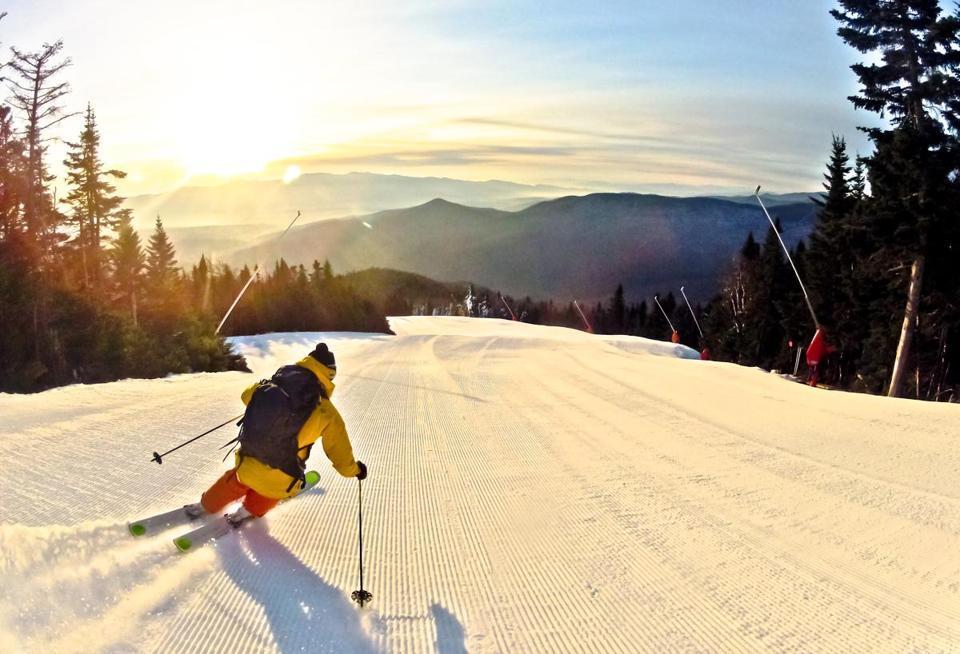 A skiier who is far more skilled than the author heads into the sunrise at Stowe Mountain Resort. Photo:  ANDERSON JAMES