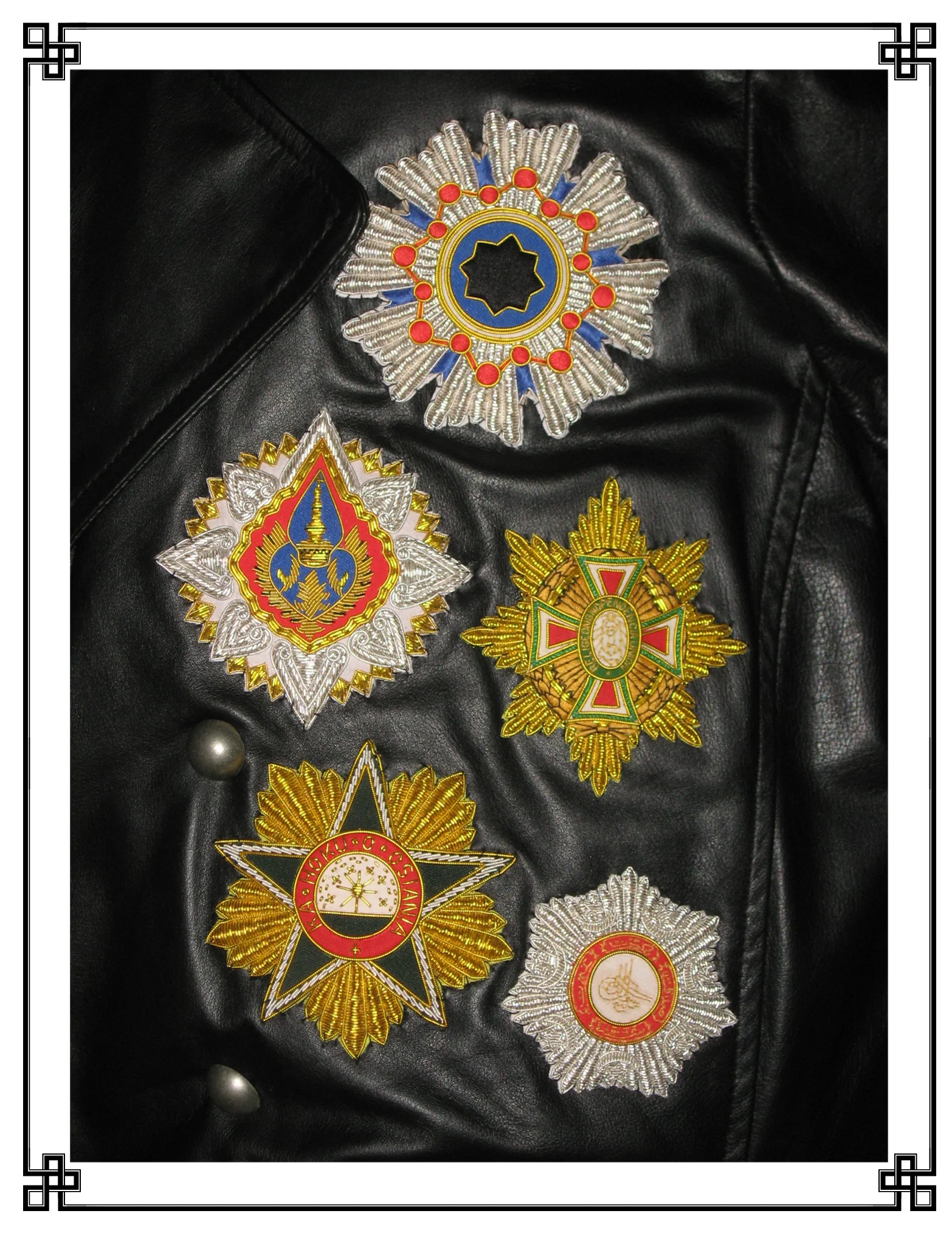 These ‘like-buttons’, indicative of the wearer’s ‘friending’ by various crowned heads of state, were amongst the most sought-after complements to any court dress. While attainable through such endeavors as the painting of a bowdlerized portrait or the sycophantic dedication of a musical composition, like-buttons were most readily acquired by means of being oneself an aristocrat and, therefore, more or less distantly related to awarding monarchs and better stationed to award reciprocal ‘friendings’ in turn. While normally given as enameled and bejeweled badges of precious metal, the examples displayed here decorate an aviator’s greatcoat. Thus, they are instead embroidered in gilt and silver thread to preclude clasp-punctures to the leather, sharp edges liable to catch on control protuberances and, in instances of extreme popularity {such as those illustrated below}, being abruptly dragged under in the event of an emergency egress over water.