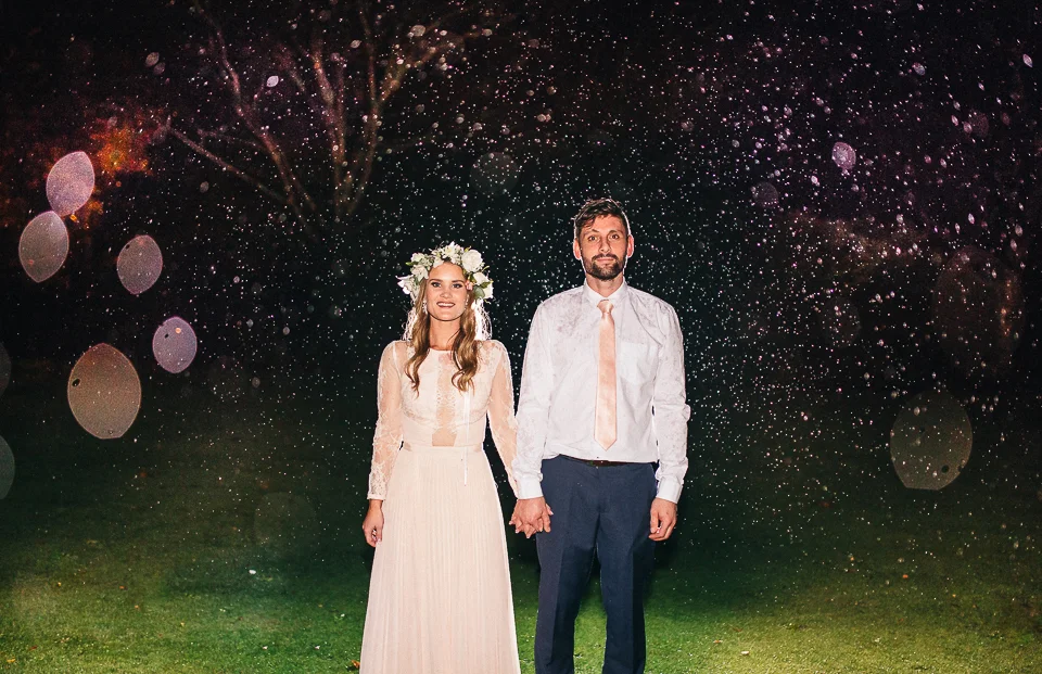 Kate + Rhys standing in the rain at Tarureka Estate