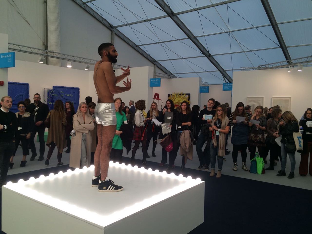  Mahmoud Khaled, Untitled (Go-go Dancing Platform) Speaks, 2016, white plinth with light bulbs, voice amplifiers, headphones and performer, 10 mins. Shown in Frieze Live, London. 