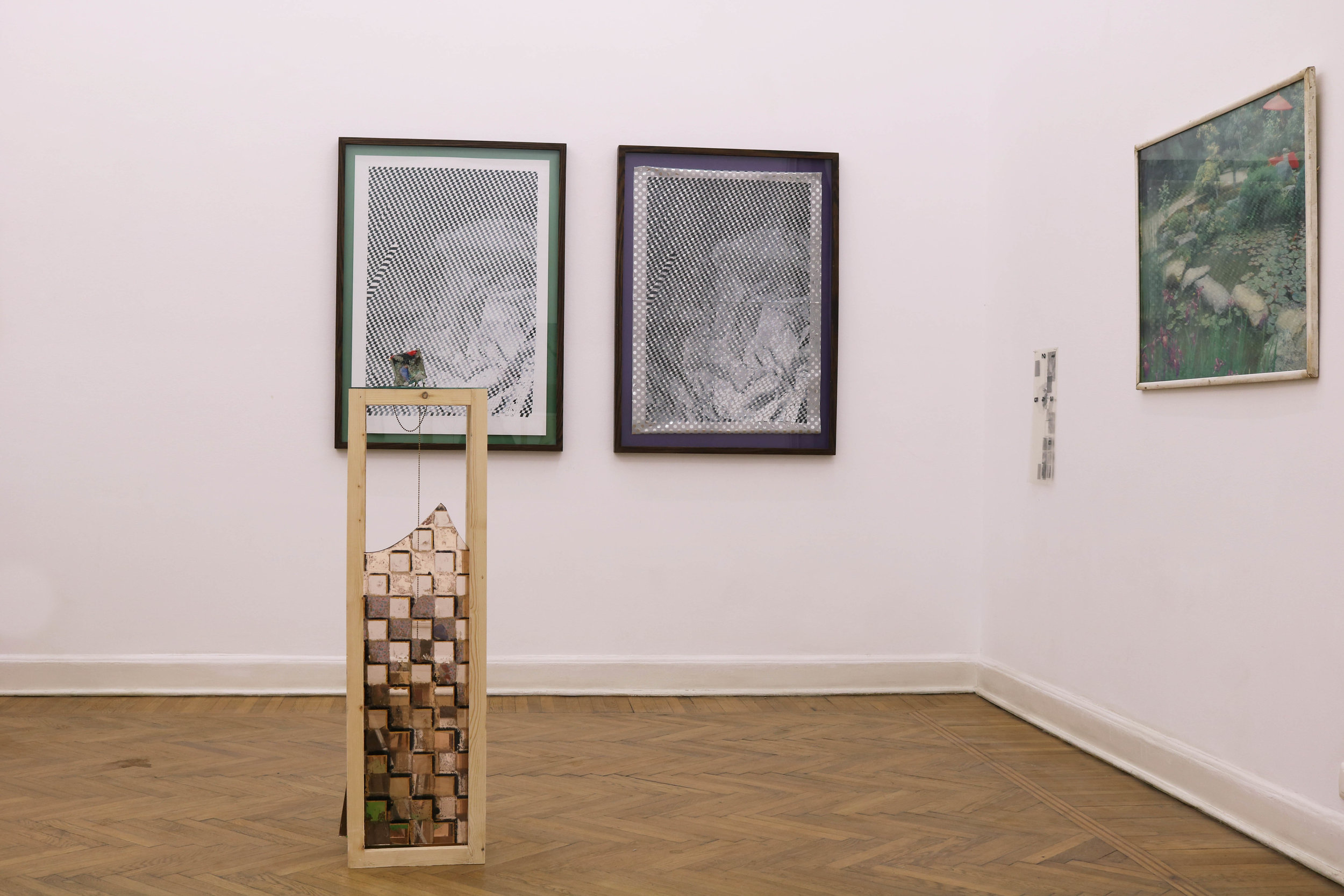  Installation view including framed picture/poster from ofce and transparencies found in the ofce. In the foreground cube sculpture (Paperweight #7) with wood pedestal. Pedestal with pieces of broken mirror and tinted mirror with silver backing scrat