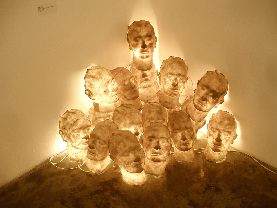  Zan’a, 2006, synthetic resin head sculptures of the artist, electric lights, dimension variable  