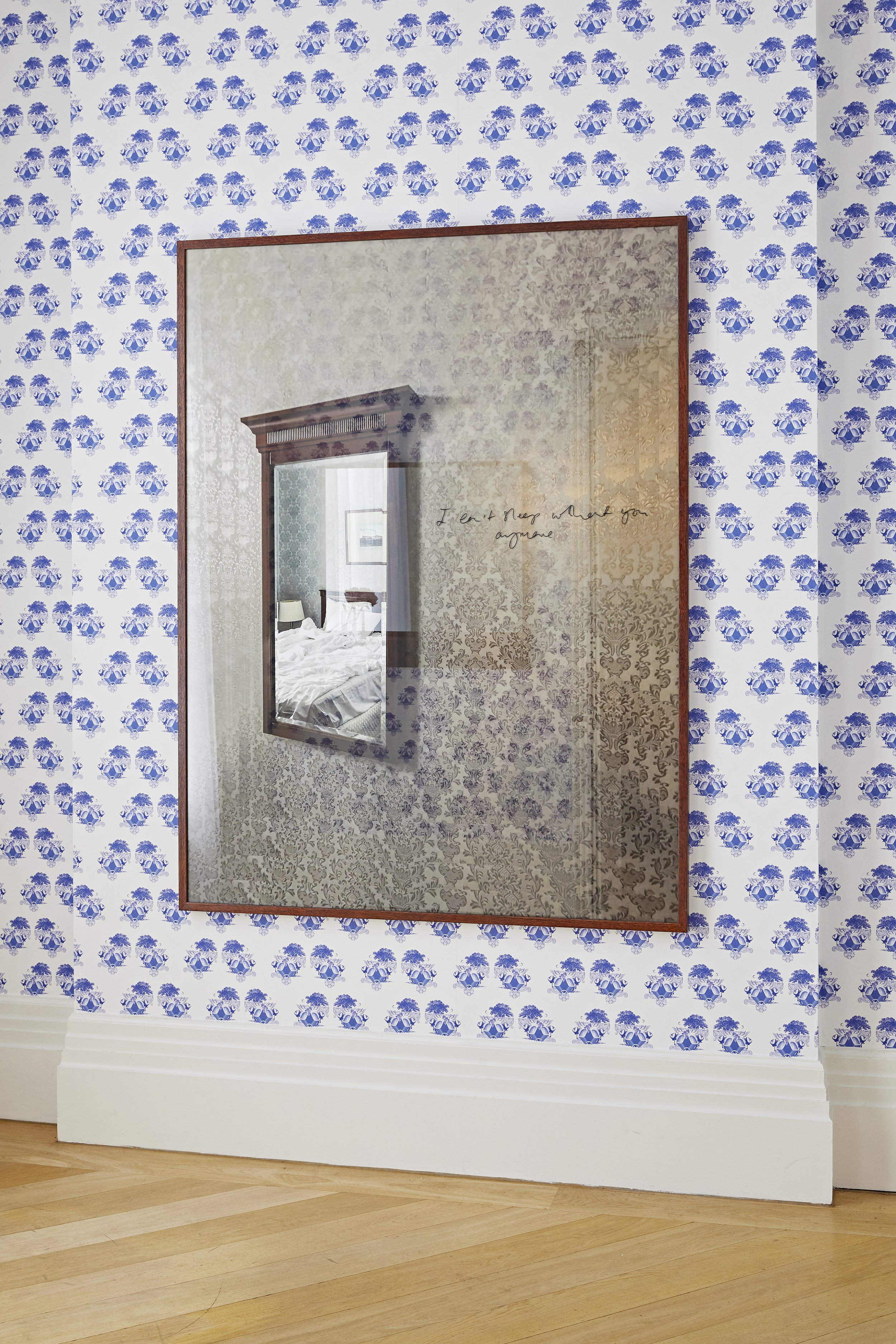  Untitled (entrance), wallpaper, wood, framed giclee photo rag print 180cm x 135cm, handwritten sentence, 2022.   Installation shot from Fantasies on a Found Phone, Dedicated to the Man Who Lost it, The Mosaic Rooms, London 2022.  