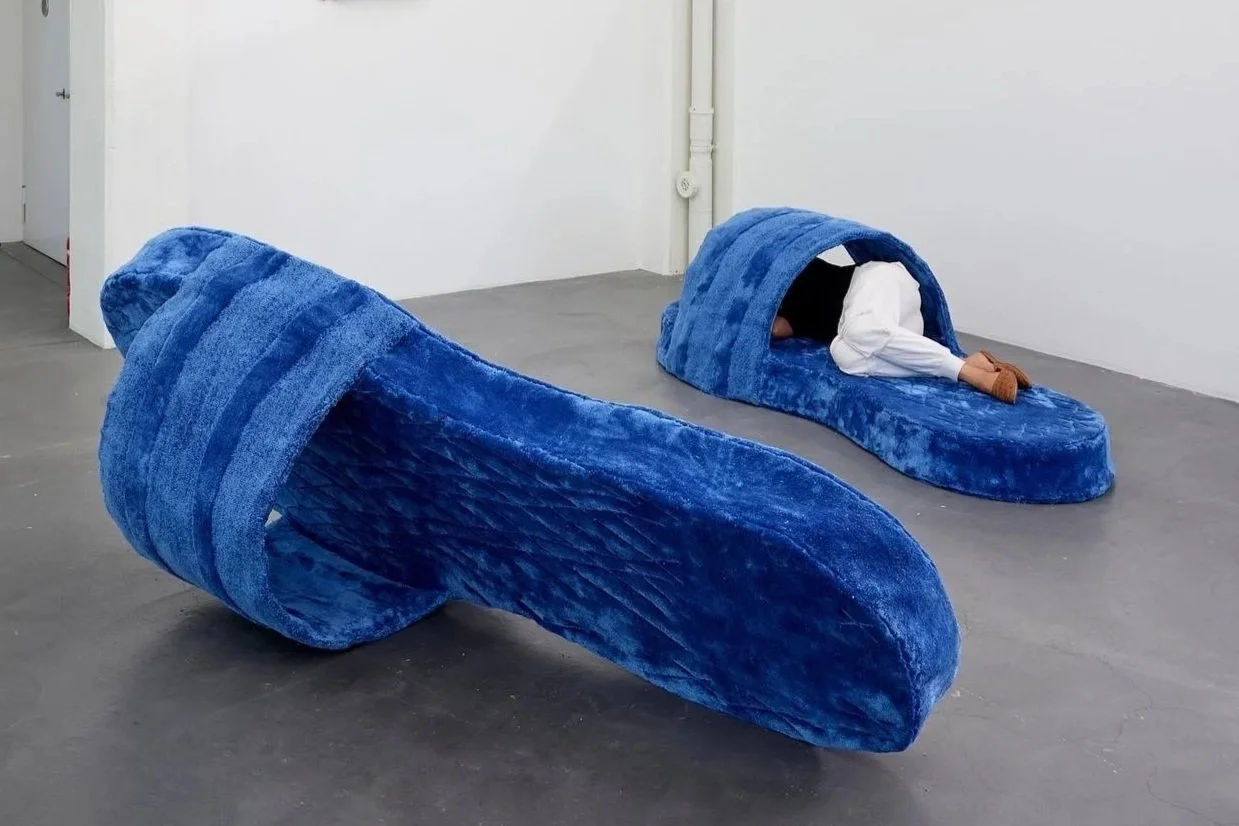   A Dialogue Between a Wooden Moth and Blue Slippers.  2022. Machine-made carpet and hand-carved cherry wood.   Installation view of  Peace or Never – Next Generation Graduation Exhibition  at Kunsthaus Baselland, Münchenstein, Switzerland, 2022. 