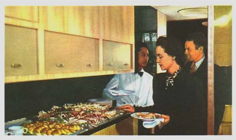 Passengers line up for the buffet in the Mainliner galley.