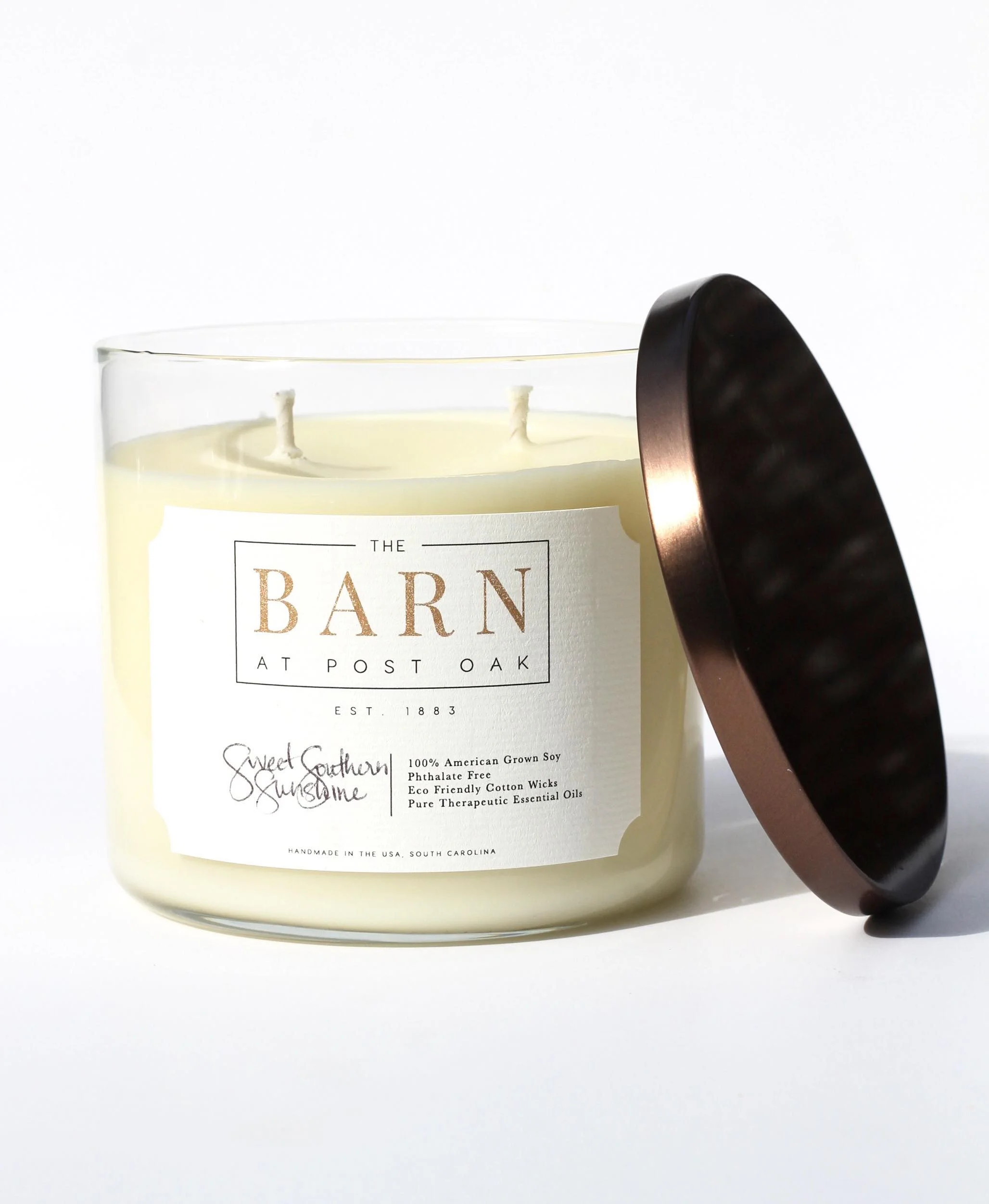 whitecandlewithbronzetophandwritingonlabel.jpg