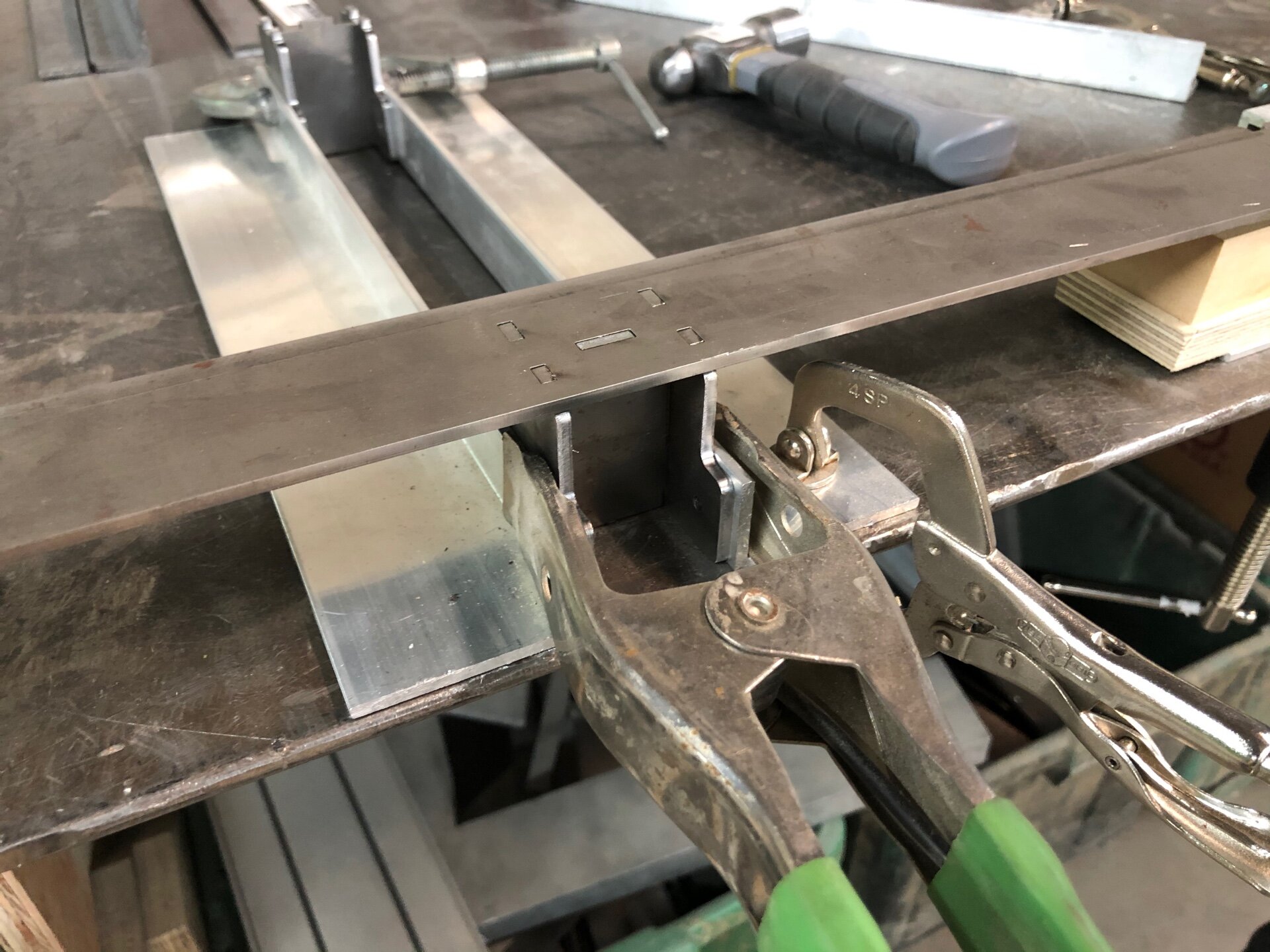 Laser-cut steel pieces in a welding fixture