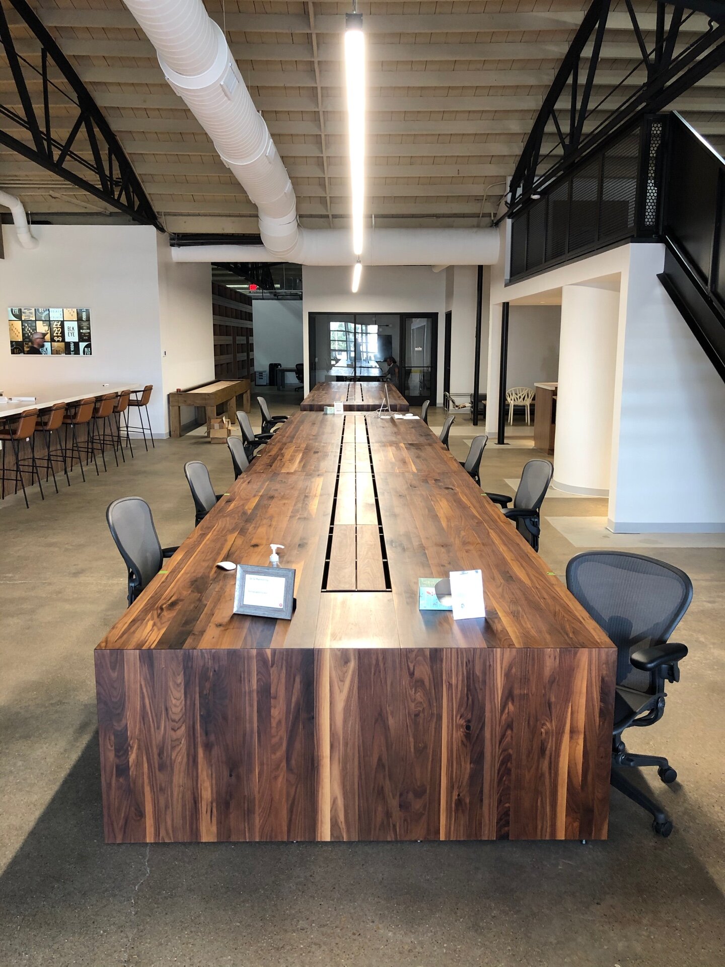 30' Walnut Waterfall Table with another 22' table in the background