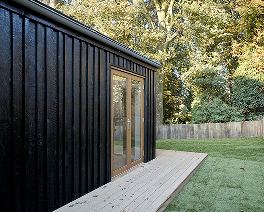 Old Malling, Lewes This timber-clad extension makes the most of its setting on the edge of a bank of mature trees by having doors on all sides. The interior is given a sense of space and drama by vaulting the ceiling and exposing the rafters.