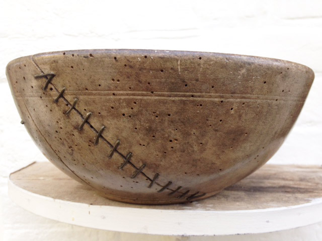 It's a stitch up! Glorious 19th Century sycamore dairy bowl, got cracked, was useless, but blacksmith repaired because they loved it so. 