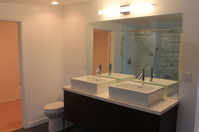 The master bath turned out amazing and feels like a boutique hotel. The shower is a dream with it's size, Hansgrohe rain shower head, and statuary marble. The freestanding tub fills the space perfectly. The double sinks on top of the same quartz counters and cabinetry as in the kitchen turned out nicely as well. There is also a vanity area next to the bathtub. 