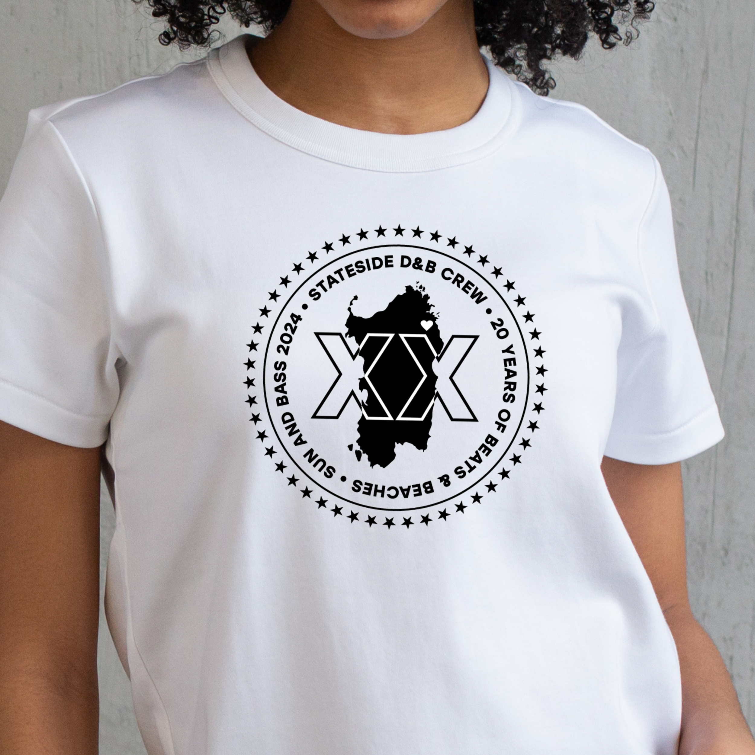 Commissioned t-shirt design celebrating the 20th anniversary of Sun and Bass in 2024. Image is an outline of a XX, set over the shape of the island of Sardenga, with a heart on the map where Sun and Bass is held. 