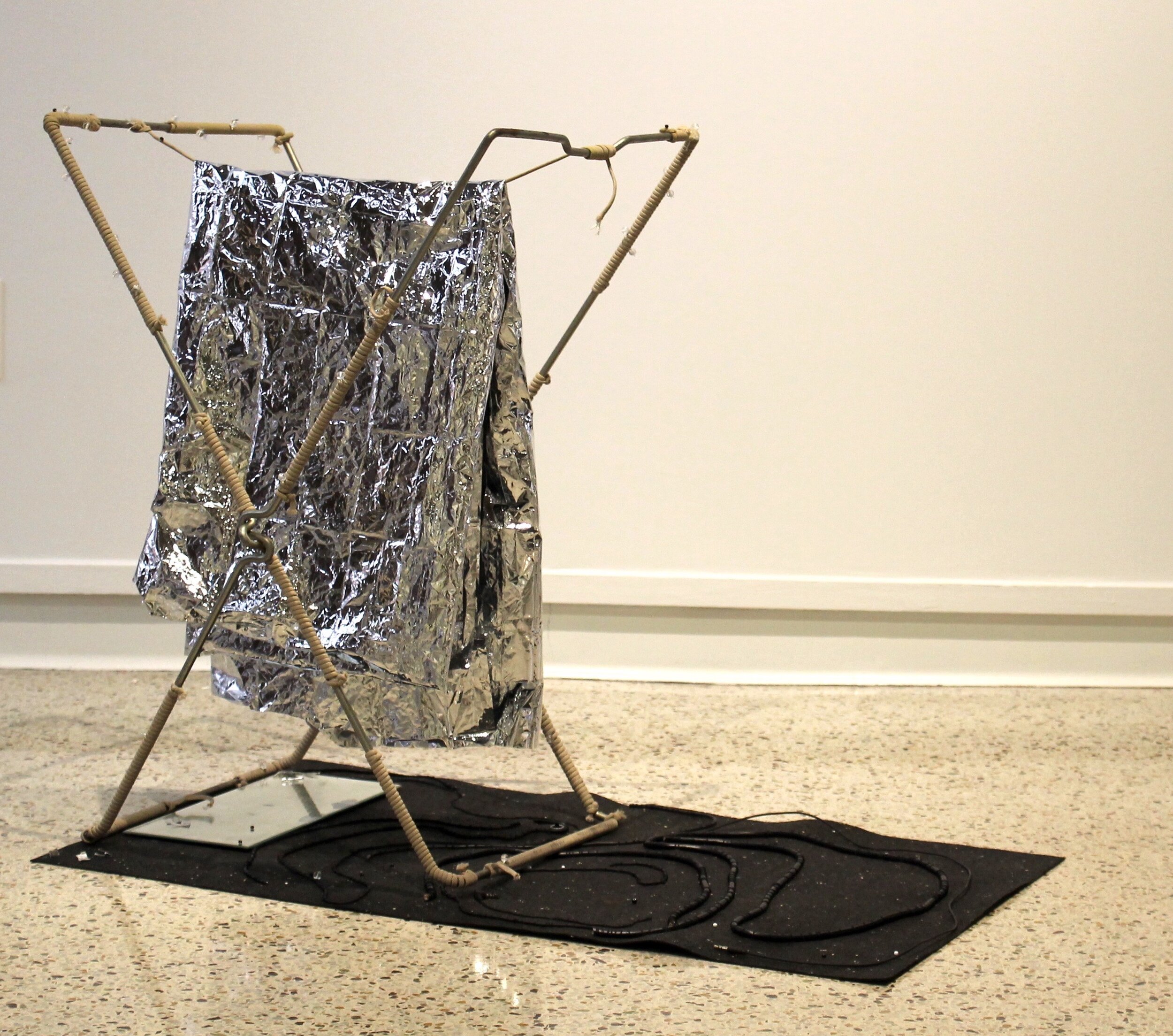First They Came 2018 Emergency thermal blanket, metal armature, mirror, electrical wires, paracord, beads