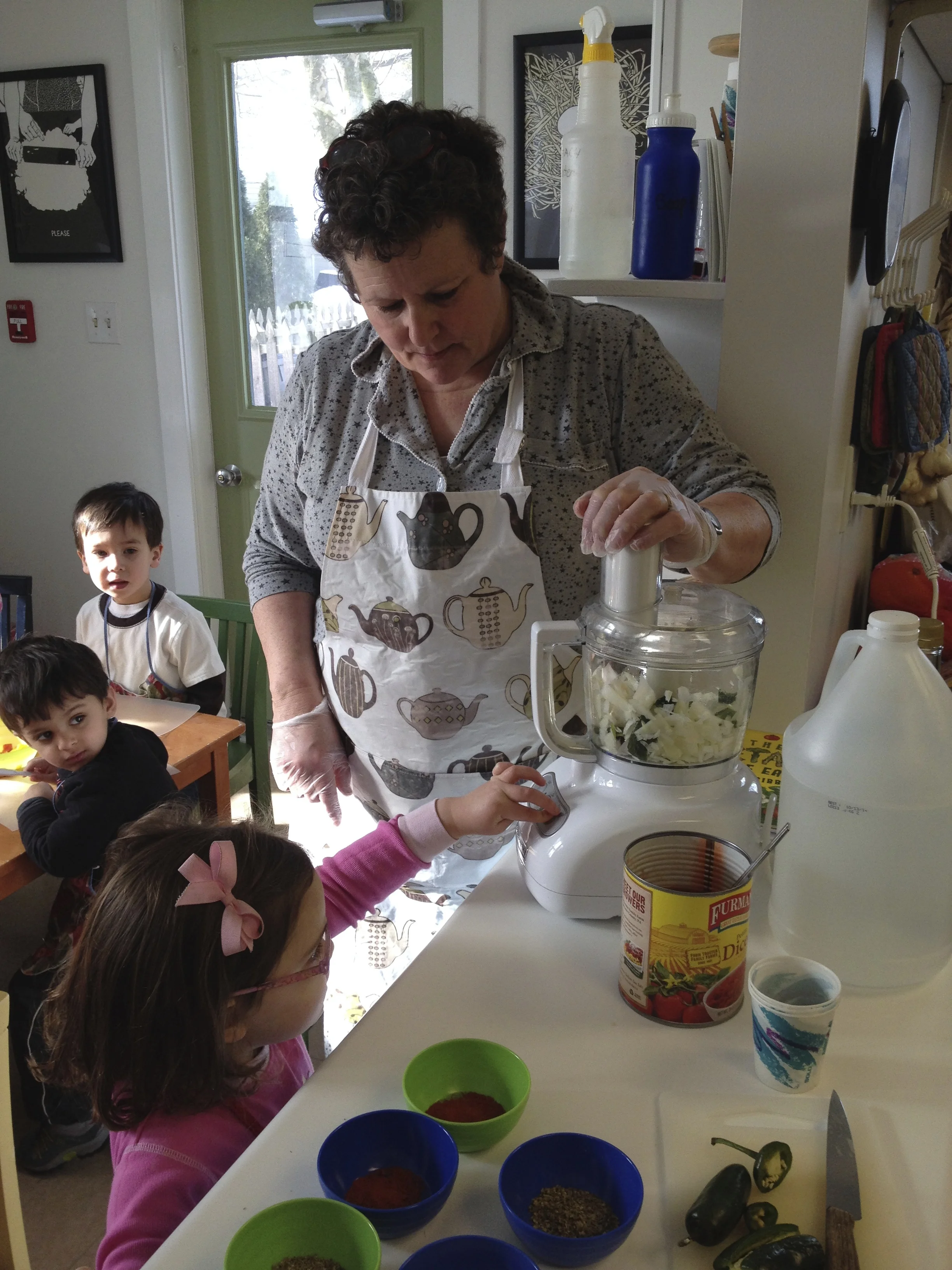 then we use the food processor to chop the onions, peppers and tomatoes