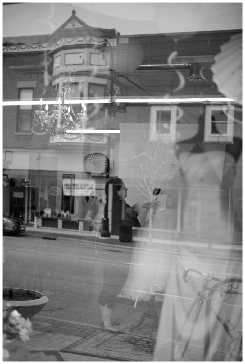Shop Owner Marissa prepare a window display 