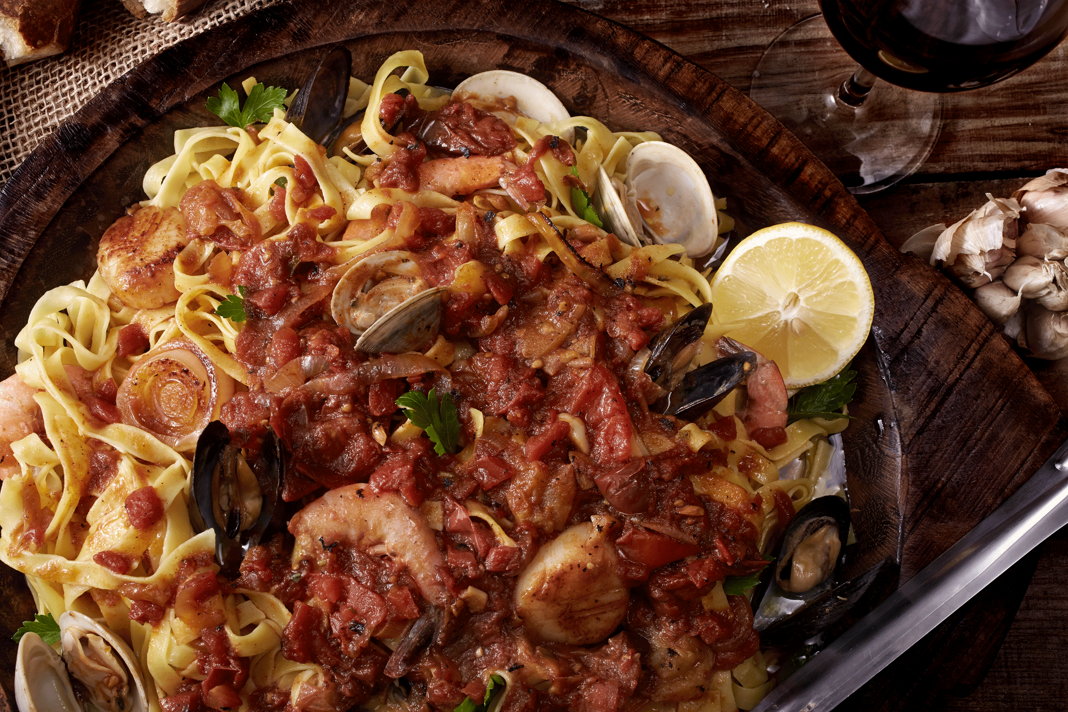 Tagliatelle, Garlic, Tomatoes, Lemon, Muscles, Clams, Shrimp, Onion, Salt, Pepper, Red Wine