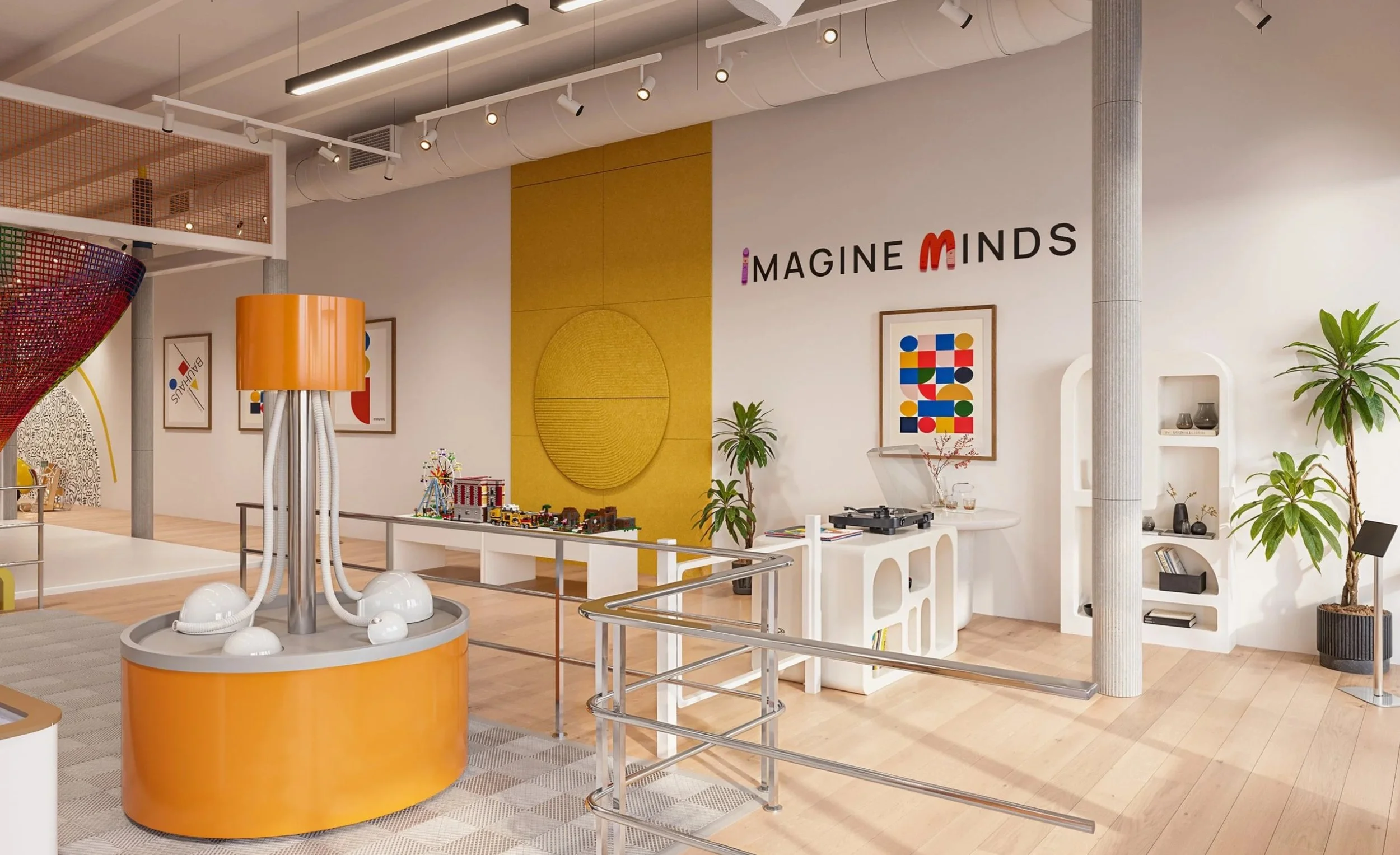 Colorful interactive children’s environment at Imagine Minds, featuring custom play Toshi's Net structures, a slide, artwork, and playful interior design by A.Masow.
