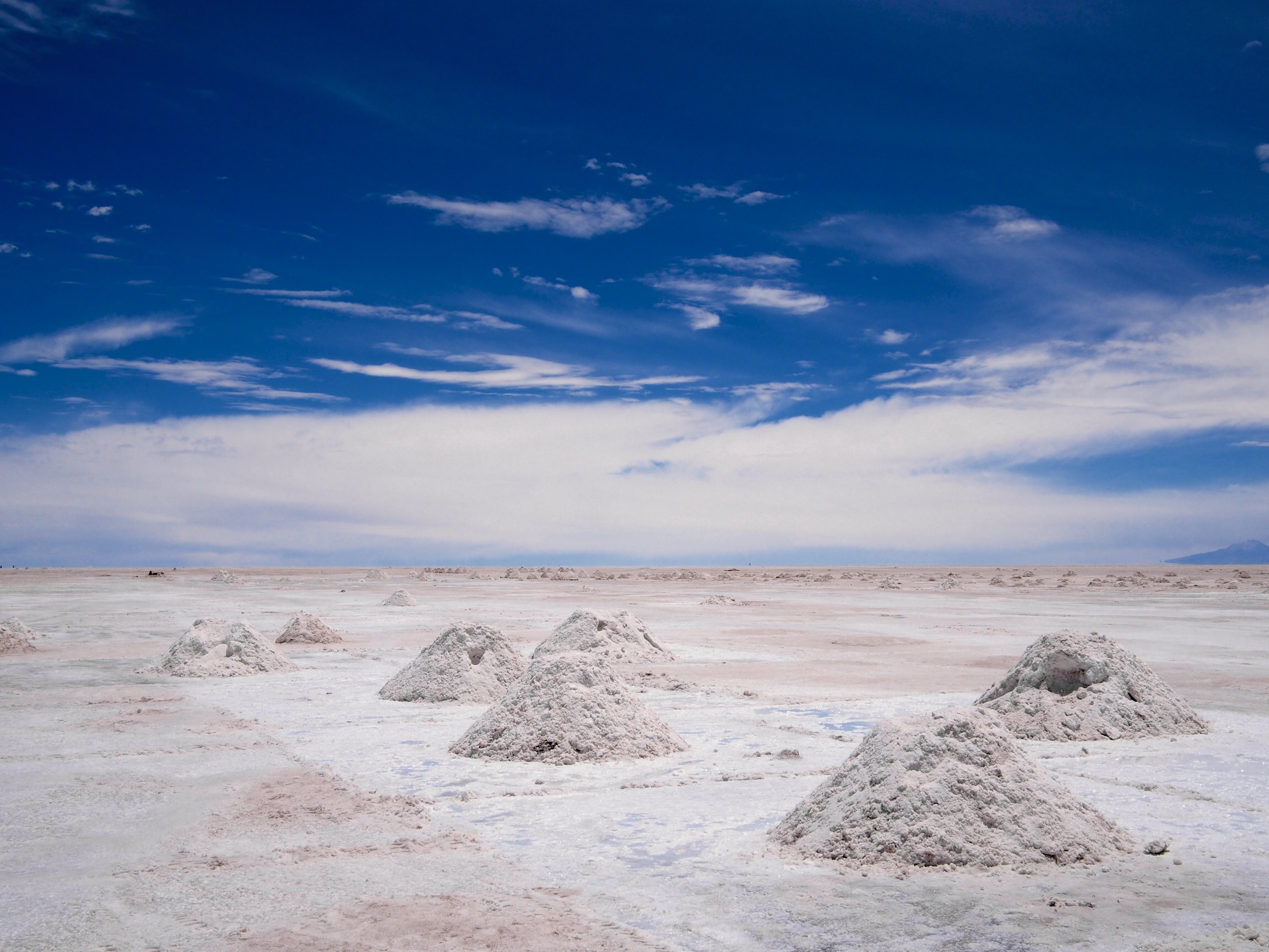 Salt is scraped off and piled into mounds ready to be transported and processed in Colchani, Bolivia