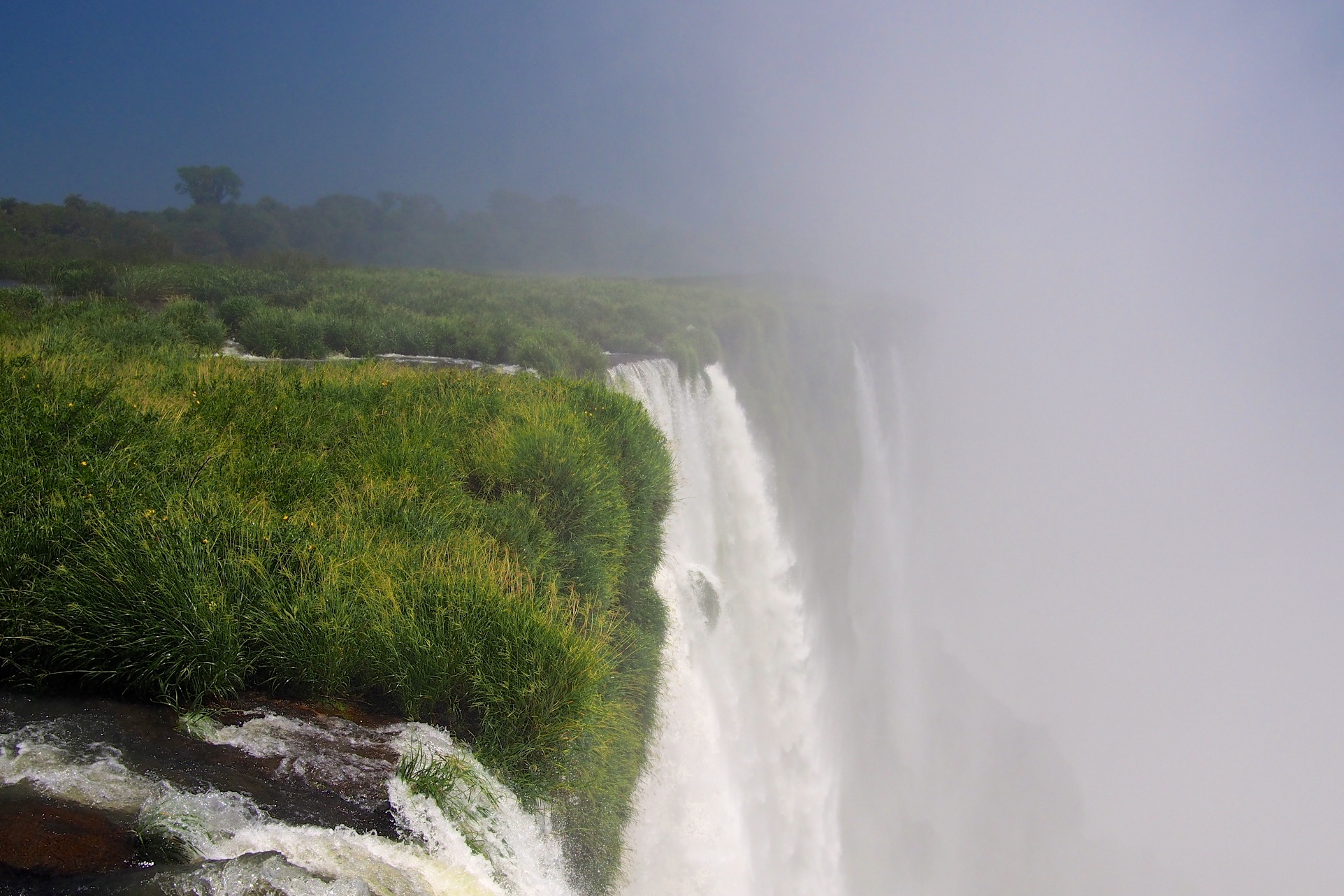 The flora is so green and full of life on both sides of the falls